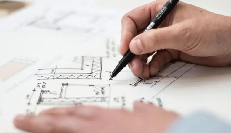 architect drawing plans for basement remodeling proejct