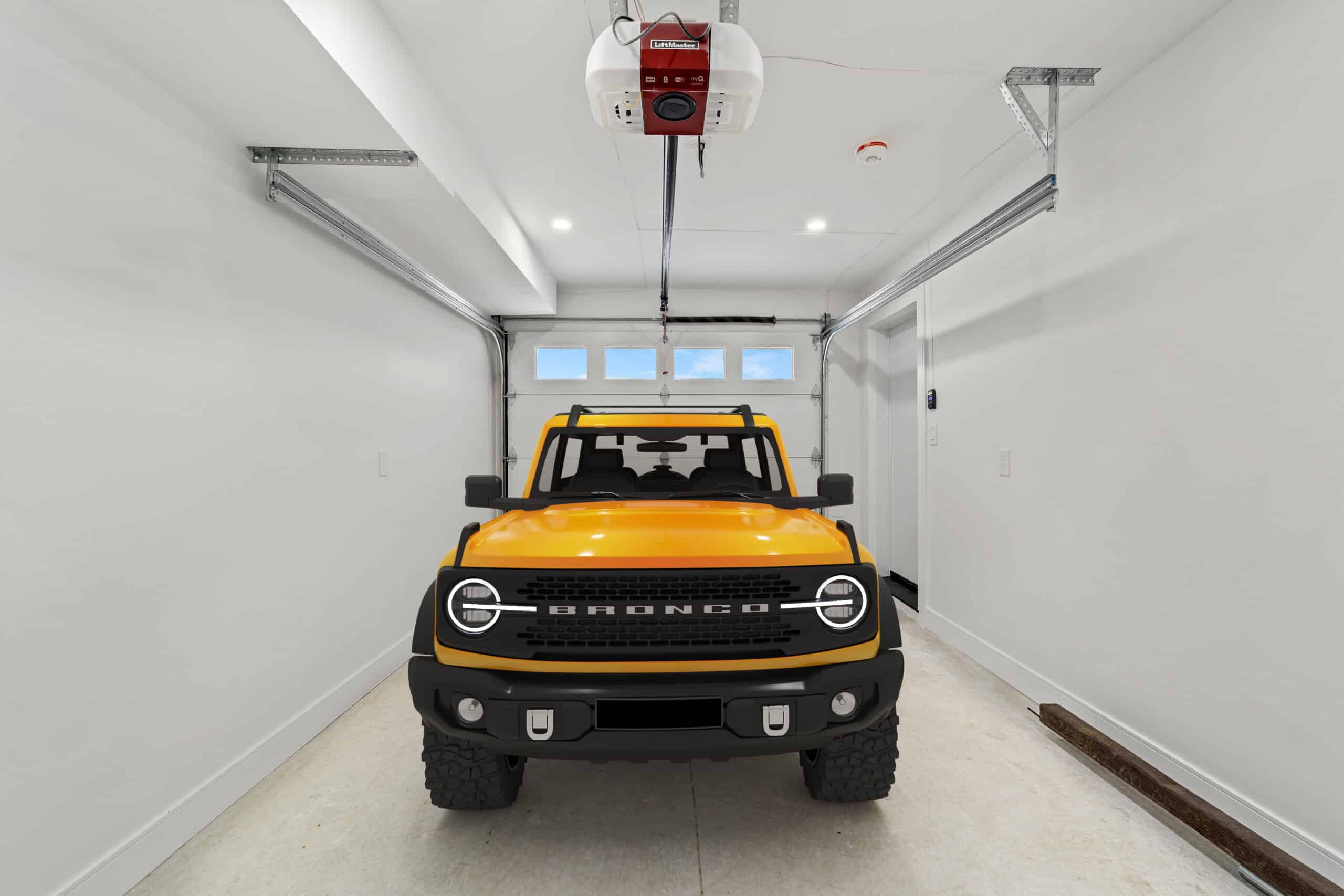 Spacious modern garage interior with yellow SUV parked inside